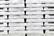 Stacked zinc ingots with numbers written on them.