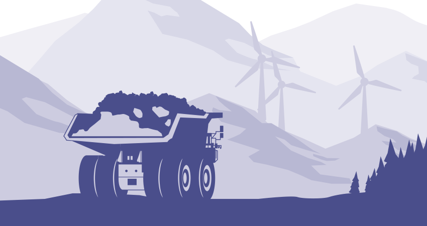 A mining truck with mountains and wind turbines in the background.