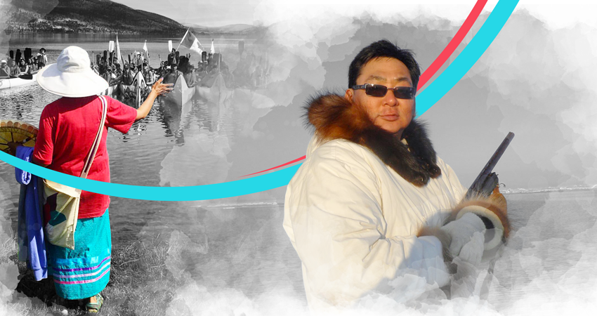 A person in a fur coat and another near canoes, with a crowd in the background.