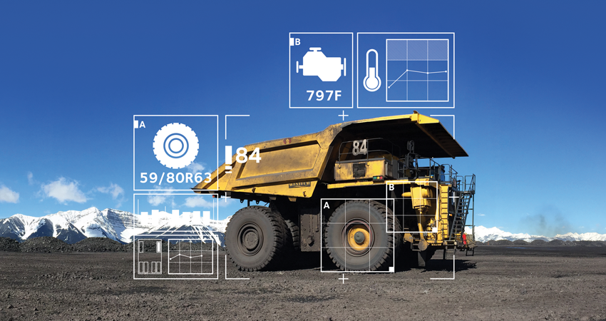 Large mining truck with data overlays, showcasing specifications and performance metrics against mountains.